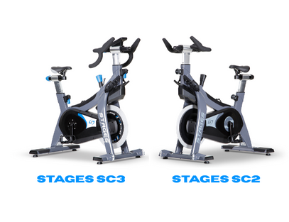Two stationary bikes labeled 'STAGES SC3' and 'STAGES SC2' on a white background