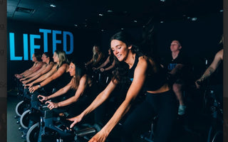 Group indoor cycling class in a fitness studio during a high-intensity spin workout