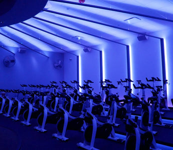 Indoor cycling studio with multiple Stages indoor bikes arranged for group fitness classes