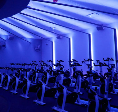 Indoor cycling studio with multiple Stages indoor bikes arranged for group fitness classes