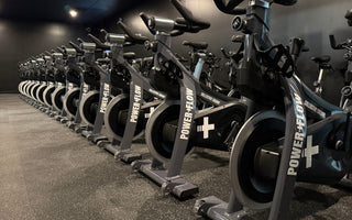 Commercial spin studio with rows of indoor cycling bikes used for group spin classes