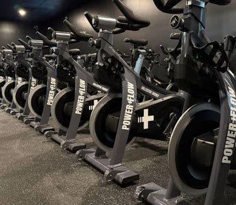 Commercial spin studio with rows of indoor cycling bikes used for group spin classes