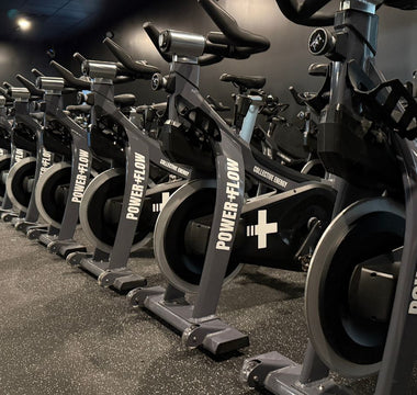 Commercial spin studio with rows of indoor cycling bikes used for group spin classes