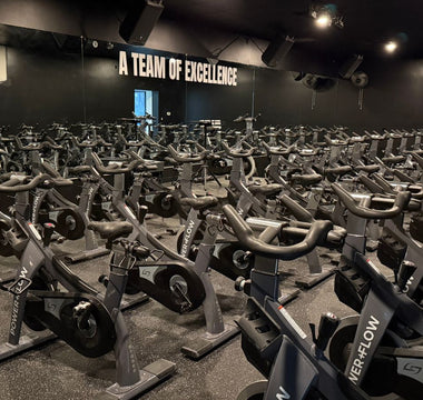 POWER+FLOW spin studio in Scottsdale Arizona with rows of commercial indoor cycling bikes used for group fitness classes