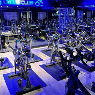 Commercial indoor cycling studio with rows of Stages indoor bikes